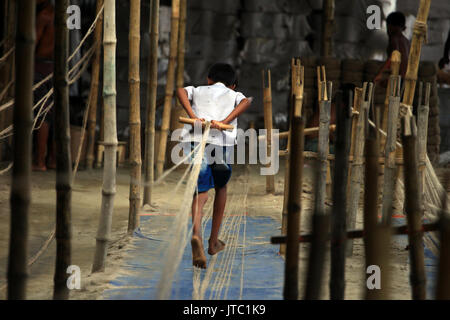 Bambino fatiche lavorando in una corda manufacturing factory a Keraniganj a Dhaka il 09 giugno 2013. Foto Stock