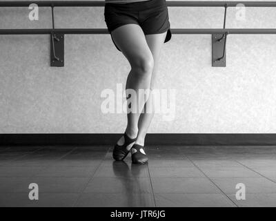 Versione in bianco e nero della danzatrice con piede smussato in Jazz posizione di scavo Foto Stock