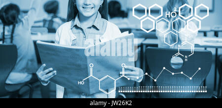 Immagine digitale della struttura chimica contro il ritratto di schoolgirl con libro in piedi in aula Foto Stock