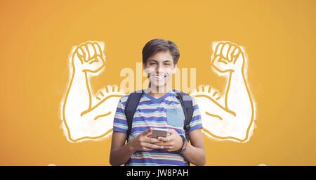 Composito Digitale di Felice studente ragazzo con i pugni grafico utilizzando un telefono contro sfondo giallo Foto Stock