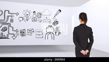 Composito Digitale di Business Woman Standing in 3D in un camera con una grafica concettuale sulla parete Foto Stock