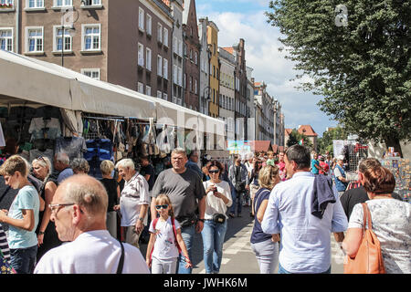 Gdansk, Polonia. 13 Agosto, 2017. Le persone in cerca di merci in un mercato delle pulci durante il 757th edizione di San Domenico la fiera sono visti in Gdansk, Polonia il 13 agosto 2017 Più di mille 1000 commercianti, artisti e collezionisti di partecipare alla fiera che occupano con i loro stand diverse strade del centro di nel centro storico della città. San Domenico's Fair è il più grande aperto di scambi ed eventi culturali in Polonia e uno dei più grandi eventi del genere in Europa. Essa ha goduto di oltre sette cento cinquanta anni di tradizione; è stata istituita dal Papa Alessandro IV nel 1260. Foto Stock