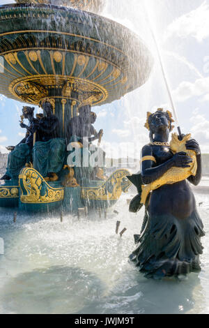 La Fontana dei mari sulla piazza della Concorde di Parigi con le statue di Nereids e Tritons che detengono pesci d'oro che sputano l'acqua al bacino superiore. Foto Stock