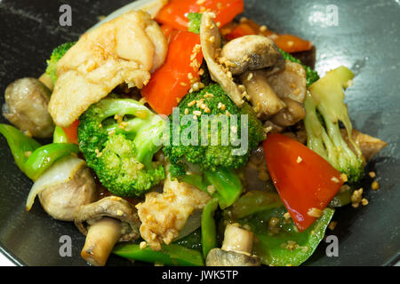 Mescolare le verdure fritte in una ciotola nero Foto Stock