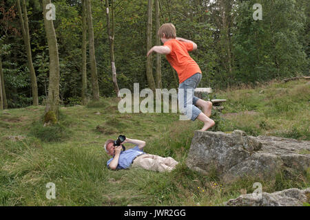 L'uomo prendendo la foto del ragazzo di salto Foto Stock