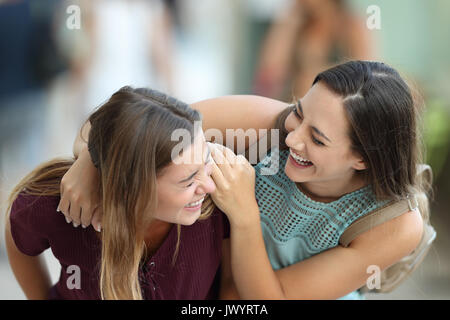 Due amici felice incontro e scherzando ridendo sulla strada Foto Stock