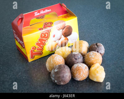 Timbits (fori di ciambella, donut fori) da Tim Hortons, un canadese popolare ristorante fast food chain. Foto Stock