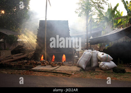 Mattone tradizionale forno usando gusci di noce di cocco per il carburante in Bali, Indonesia Foto Stock