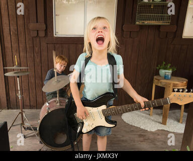 I bambini a suonare la chitarra e percussioni in banda Foto Stock