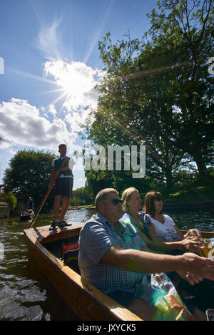 Scudamore sterline sul fiume Cam, Cambridge. Pubblico punting auto con autista e gli scommettitori. Collegi universitari e gli edifici in background. Foto Stock