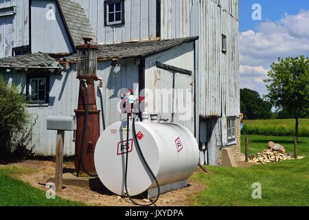 Pompa Vintage siede tra la cassetta postale e il giorno corrente propano serbatoio su farm nel nordest Illinois, Stati Uniti d'America. Foto Stock