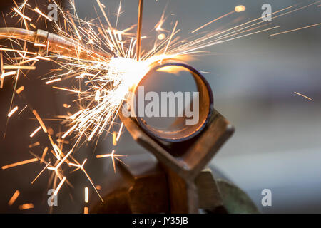 La saldatura, con una torcia di saldatura di due tubi di metallo vengono saldate, seminario di formazione per riscaldamento e idraulici artigiani, Foto Stock