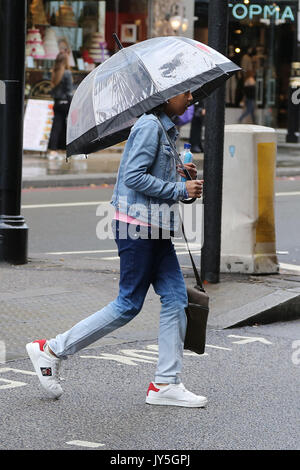 Knightsbridge. Londra, Regno Unito. 18 Agosto, 2017. Persone riparo sotto un ombrello da pioggia in Knightsbridge. Credito: Dinendra Haria/Alamy Live News Foto Stock