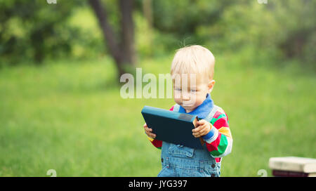 Un anno di età del bambino la lettura di un libro Foto Stock