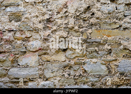 La texture del vecchio castello medievale di parete costituita da pietre grigie. Foto Stock