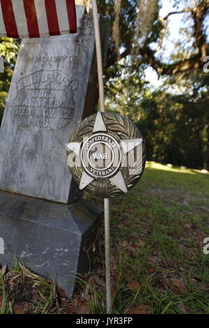 Confederato veterano di guerra evidenziatore lungo con entrambi i flag di confederati e la bandiera americana in un cimitero storico vicino a Ocala, Florida Foto Stock