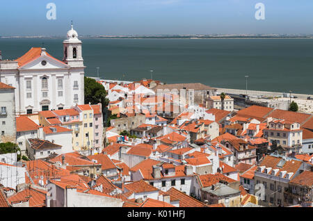 Tetti di terracotta e l'antica chiesa visto da Miradouro Alfama uno dei tanti punti di vista di Lisbona Portogallo Europa Foto Stock