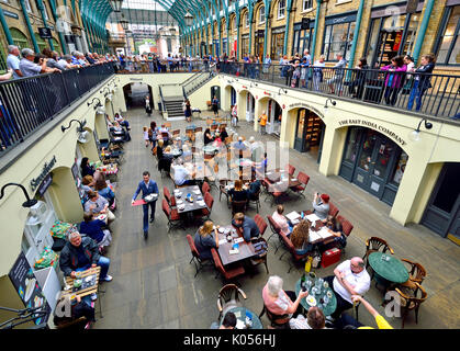 Londra, Inghilterra, Regno Unito. Mercato di Covent Garden - ristoranti negozi e caffetterie sotto il coperchio Foto Stock