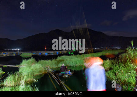 KINTAMANI, Indonesia - 1 giugno: Unidentiifed fisherman cast glow in the dark esche di notte nel Danau Batur lago vicino monte Batur in Kintamani, Indo Foto Stock
