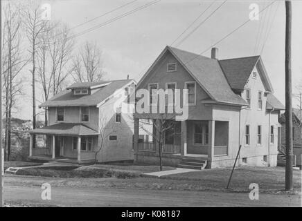 Fotografia di due Roland Park Homes in Baltimore, entrambi a due piani di abitazioni con spaziose verande, situato su una collina, né fatta di mattoni, ma con grandi Baltimore-stile windows, oltre ad alberi con foglie di no, Stati Uniti, 1920. Questa immagine viene da una serie di documentare la costruzione e la vendita di case nel parco di Roland/Guilford quartiere di Baltimora, un tram sobborgo e una delle prime comunità prevista negli Stati Uniti. Foto Stock