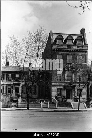 Due edifici a sedersi su una strada con un viale alberato di marciapiede in Baltimore, Maryland, uno (sinistra) con il segno di un sarto, arbusti, ad un breve tratto di recinzione, finestre con persiane, e camini; gli altri (a destra) il mattone, con una piccola scalinata che conduce alla porta d ingresso, arbusti, un camino, top-story finestre dormer e pietra ornata accenti, Baltimore, Maryland, 1910. Questa immagine viene da una serie di documentare la costruzione e la vendita di case nel parco di Roland/Guilford quartiere di Baltimora, un tram sobborgo e una delle prime comunità prevista negli Stati Uniti. Foto Stock