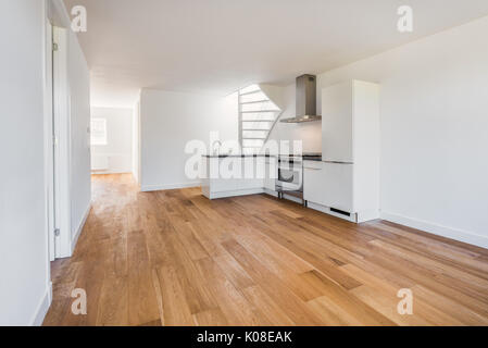 Svuotare Soggiorno con pavimento in legno, cucina e per le scale Foto Stock