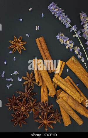 Senso di spezie cannella e anice stellato del whit della candela su sfondo nero con spazio di copia Foto Stock