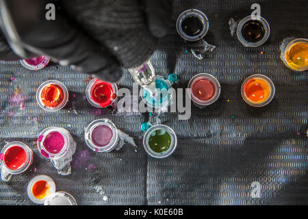 Tattoo Artist ricarica della penna con inchiostro blu. Scatto dall'alto Foto Stock