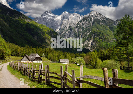 Bovec locale Trenta agriturismo architettura in alta valle alpina di Zadnja Trenta con Snow capped Razor picco nel Parco Nazionale del Triglav Slovenia Foto Stock