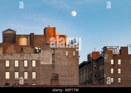 Full Moon Rising al di sopra di vecchi edifici in mattoni intorno a Union Square Park a Manhattan, New York City NYC Foto Stock