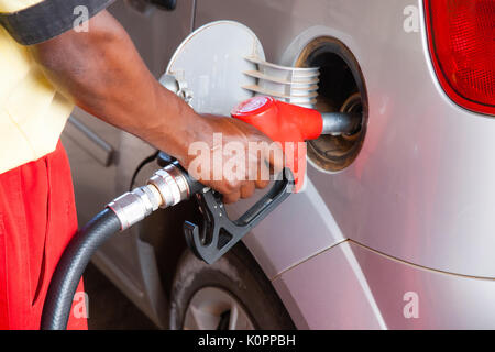 Il rifornimento di carburante per auto presso la stazione di benzina. Concetto di immagine per l'uso di combustibili fossili (benzina, diesel) nei motori a combustione e ambientali ed occupazionali Foto Stock