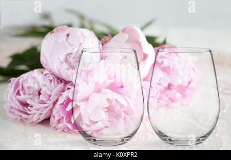 Floral mock-up di stemless 2 bicchieri di vino, di fronte ad un mucchio di peonie, perfetto per le aziende che vendono le decalcomanie di vinile, adesivi, appena sovrapporre la d Foto Stock