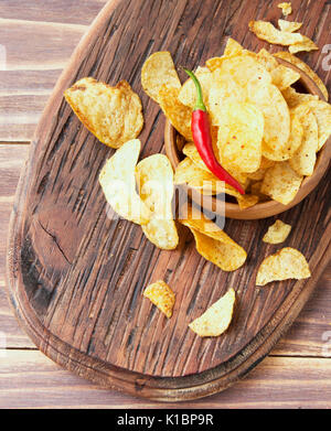 Chip in una ciotola di legno sul tavolo di legno, fuoco selettivo Foto Stock