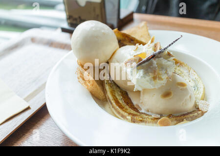 Crêpe con gelato e banana bruciato topping. Una crêpe è un tipo di molto sottile pancake (soft focus) Foto Stock