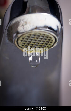 Il vecchio perde il rubinetto con pietra e sedimenti di calcio a causa di acqua dura. Foto Stock