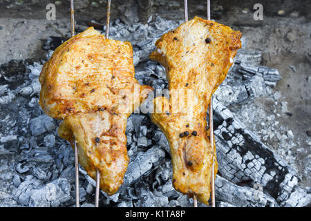 Il shish kebab da carni prepara su carbone di legna. I pezzi di carne sono su spiedini Foto Stock