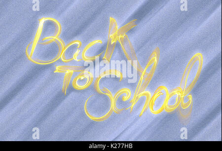 Si torna a scuola parole scritte fatte di fumo blu su sfondo sabbia. Foto Stock