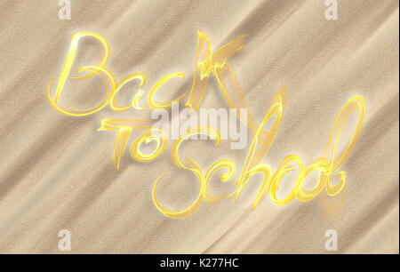 Si torna a scuola parole scritte fatte di fumo sul biege Sfondo sabbia. Foto Stock