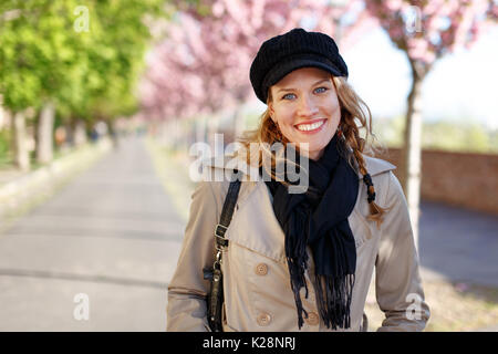 Felice giovane donna sorriso toothy all inizio della primavera nel parco Foto Stock