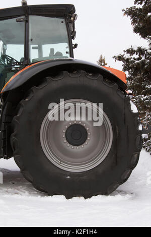 Pneumatico della ruota di un trattore agricolo a Winter Snow Day Foto Stock