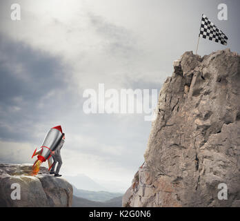 La determinazione e la potenza imprenditore che detiene un razzo per raggiungere la bandiera Foto Stock