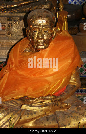 Monaco statua ricoperta in foglia oro in Thailandia tempio Foto Stock