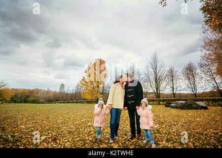 La famiglia passeggiate nel parco in autunno. Foto Stock