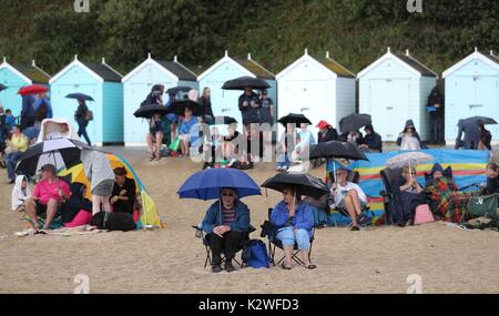 Persone rifugio sulla spiaggia per il primo giorno del 2017 Bournemouth Air Festival. Foto Stock