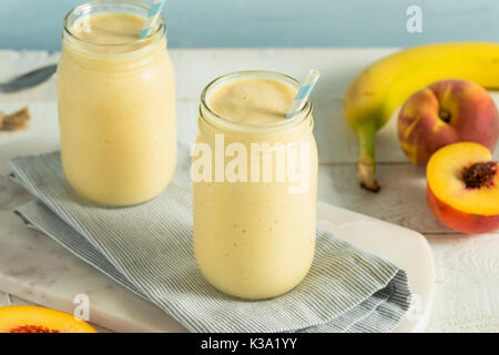 In casa sano frullato di pesche con ananas e banane Foto Stock