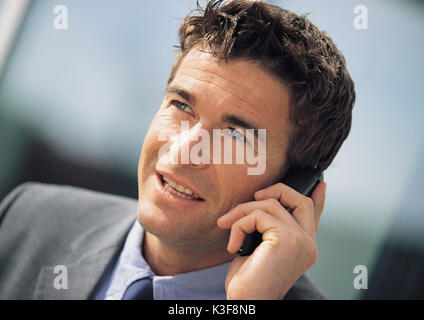 Imprenditore telefona con un cellulare Foto Stock