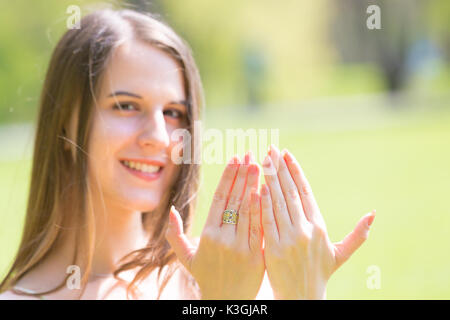 Ritratto di giovane bella donna con capelli lunghi mostra bellissimi chiodi sulle mani Foto Stock