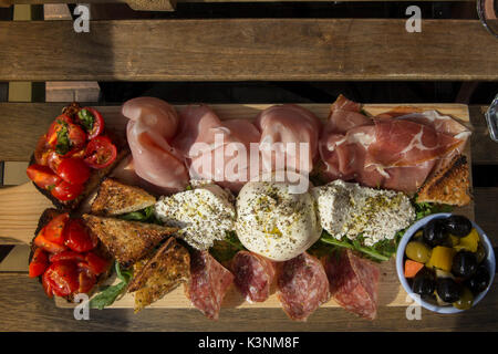 Una diffusione di affettati e cibo italiano a pranzo Foto Stock