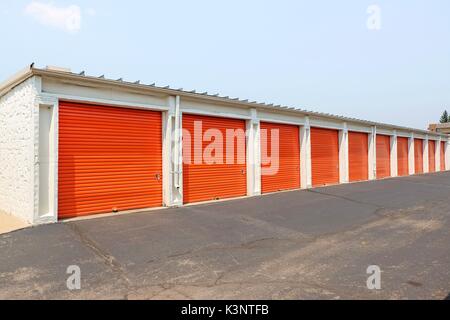 Fila di un arancio porte metalliche di un ammasso pubblico, prospettiva Foto Stock