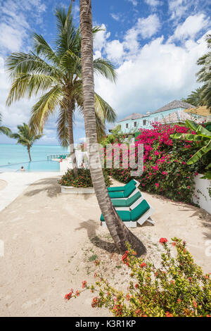 Lettini e palme che si affaccia sul Mare dei Caraibi Ffryes Beach le roccie Antigua e Barbuda Isola sottovento West Indies Foto Stock